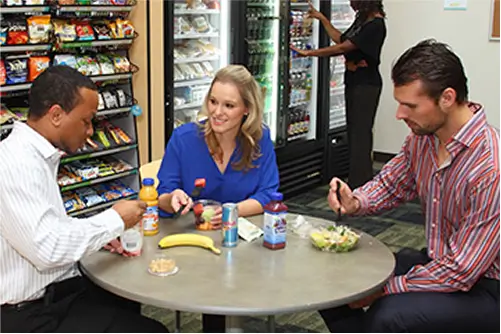 Home 12 People enjoying snacks in breakroom